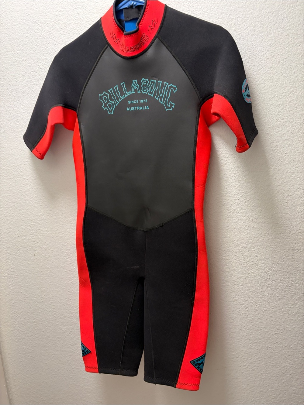 Billabong  Women's Short Sleeve Rashguard in Black and Red with Teal Logo